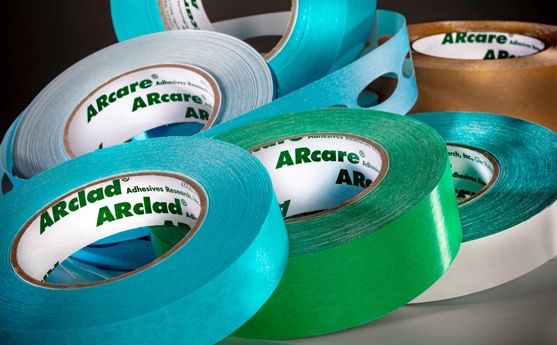Assorted colorful adhesive tapes with 'ARcare' and 'ARclad' branding.