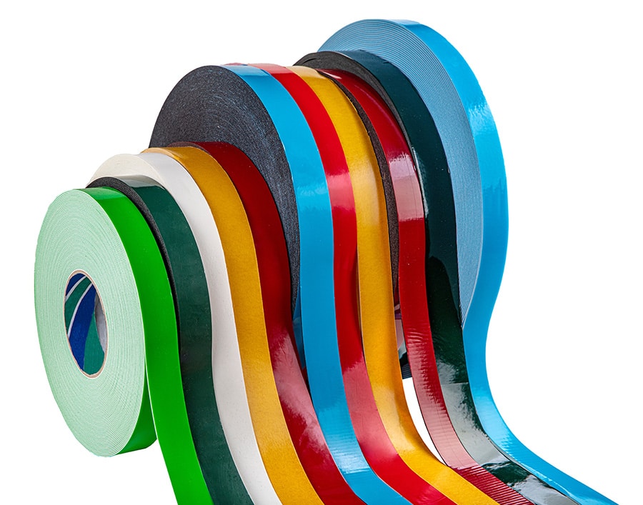Colorful rolls of adhesive tape in various colors and widths.