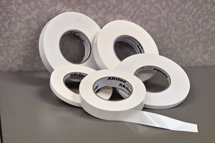Five rolls of white adhesive tape on a table