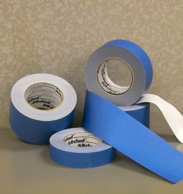 Rolls of blue masking tape on a table.